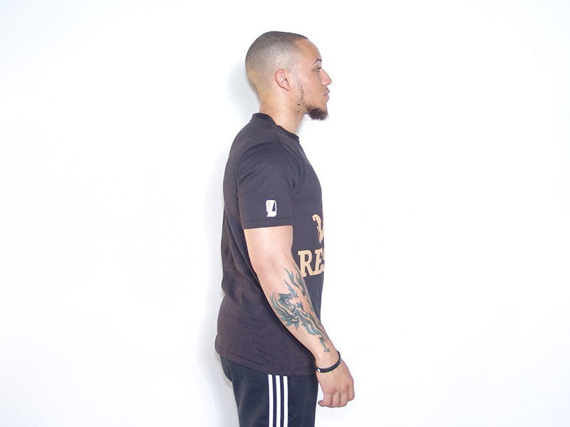 Black graphic T-shirt side view with partial gold text print