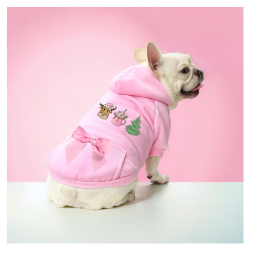 Dog wearing pink hoodie with reindeer print on chest and satin bow