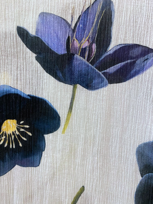 Cotton crepe fabric close-up with navy and blue flower print on white background
