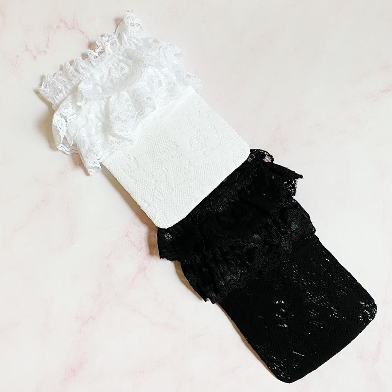 Pair of lace socks: white sock and black sock with ruffled cuffs