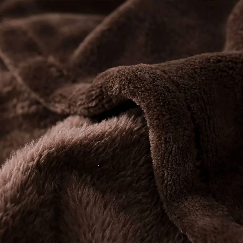 Close-up of dark brown plush blanket with soft shag texture