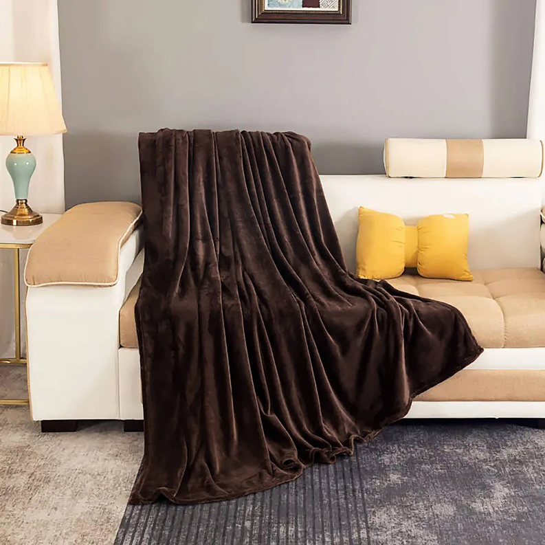 Brown plush throw blanket draped over sofa arm and seat