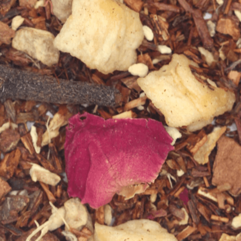 Loose-leaf tea blend with dried tea leaves and petals in brown, pink, and tan pieces
