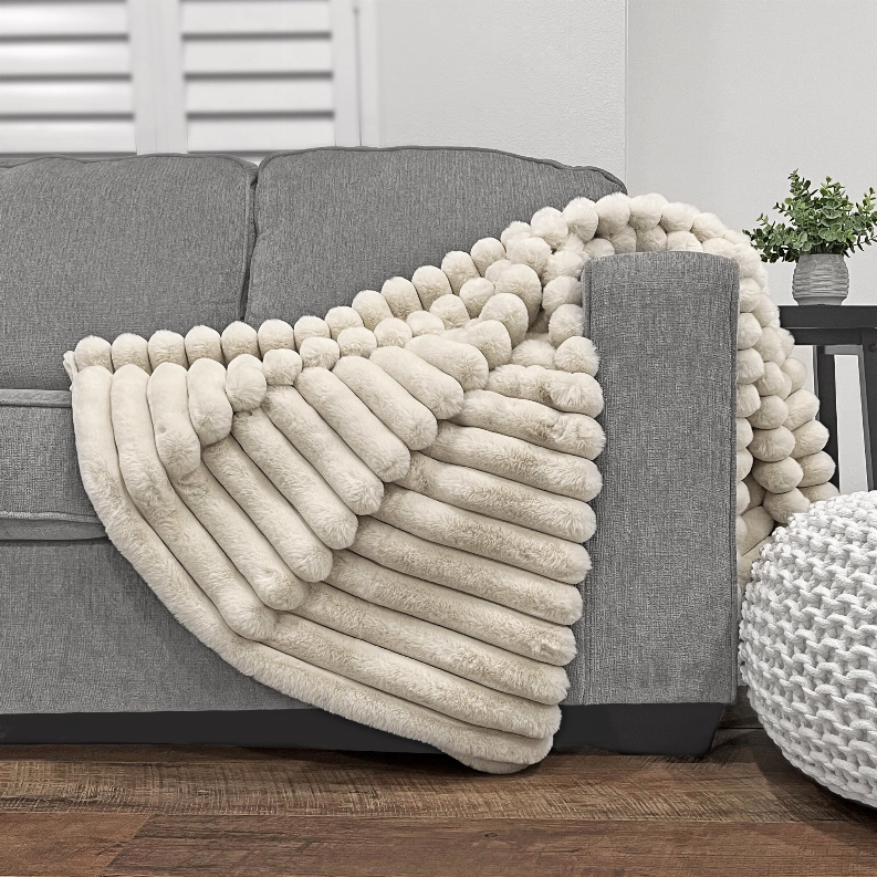 Ivory puff faux fur throw, folded with ridged pebble-texture design