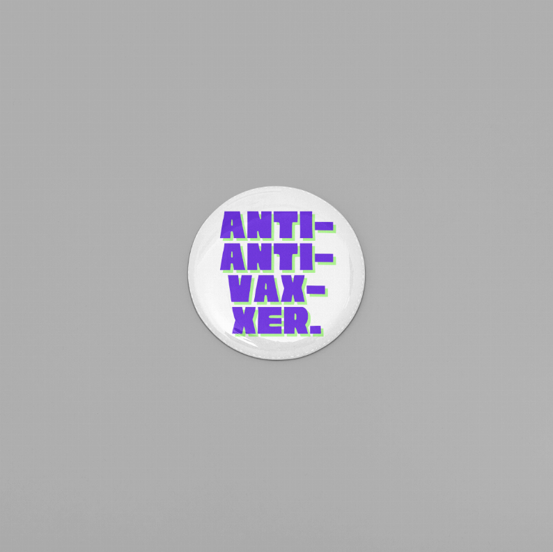 Round enamel pin with purple “ANTI-ANTI-VAXXER” text on a white background