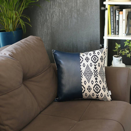 Throw pillow cover featuring black geometric design panel with dark blue faux leather look back