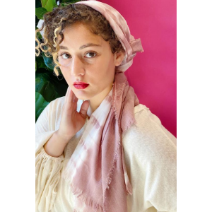 Mauve tie-dye scarf with soft fringe ends, worn as a neck wrap