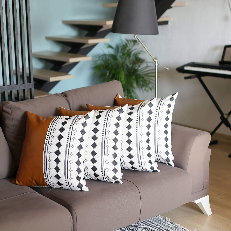Set of 4 throw pillows: white-and-black patterned covers with orange accent pillows