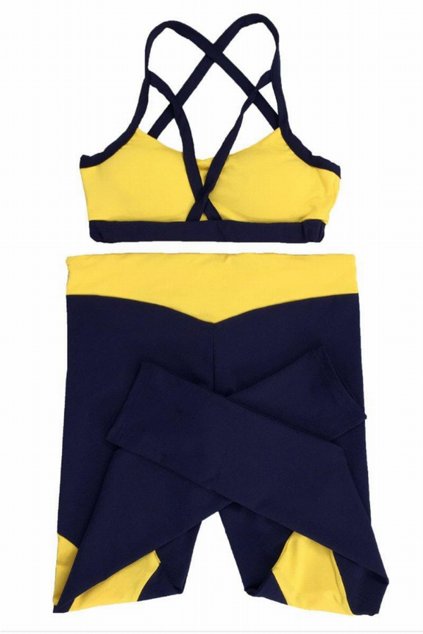 Navy and yellow yoga set with crisscross sports bra and leggings, panel accents