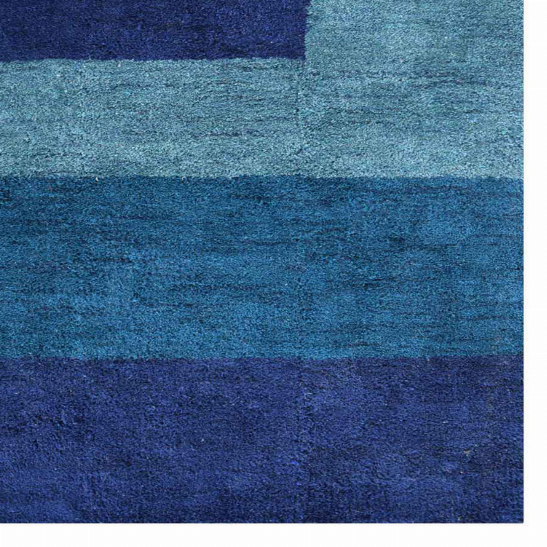 Close-up of blue and teal rug texture with horizontal stripe bands
