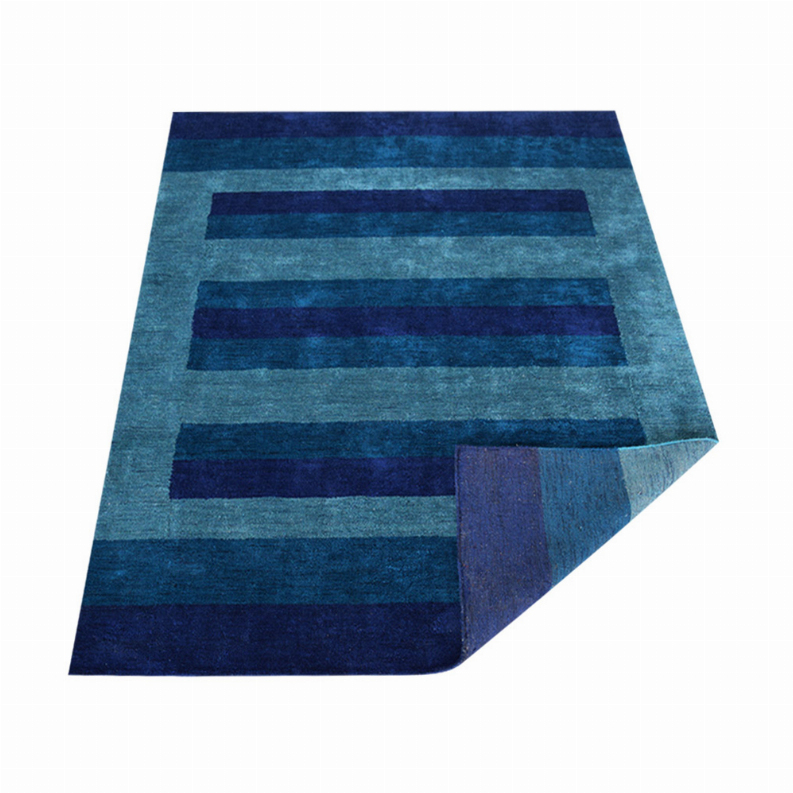 Rectangular area rug with teal and navy stripe bands, corner detail