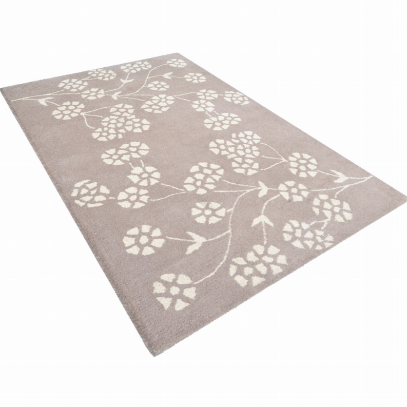 Taupe hand-tufted wool area rug with scattered white floral rosettes, flat lay