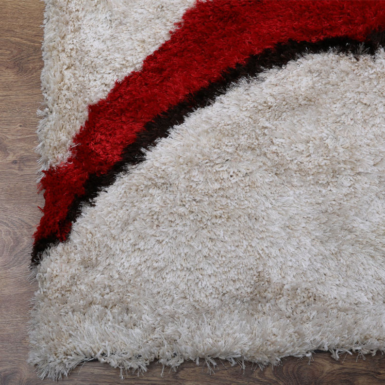 Shag rug corner with white pile, red band, and black trim detail