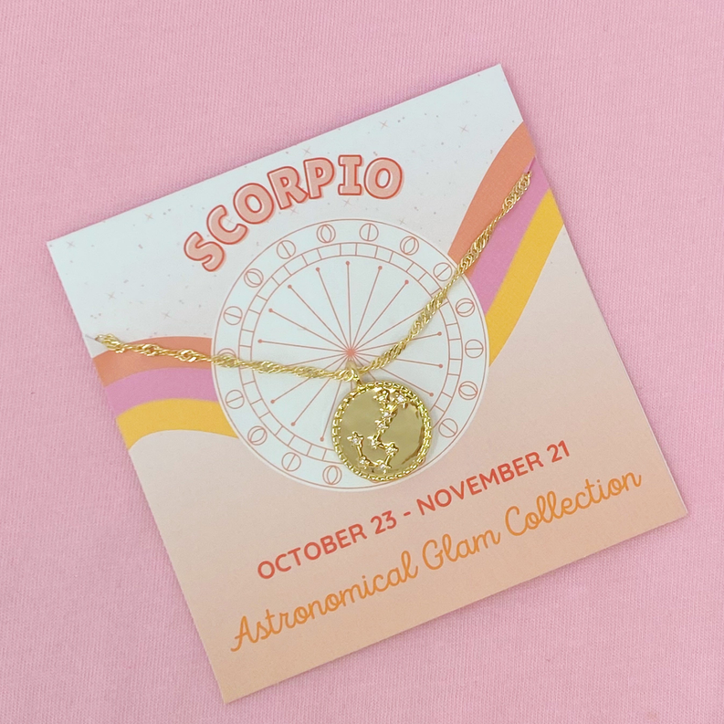 Gold chain Scorpio charm necklace on zodiac wheel display card