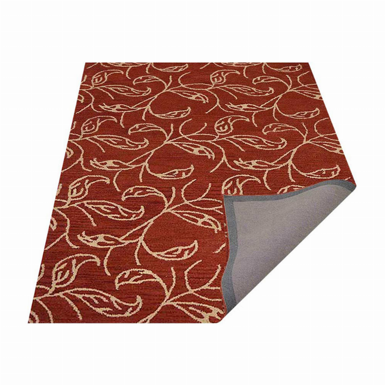 Rust red area rug with cream floral design and gray underside visible at edge.