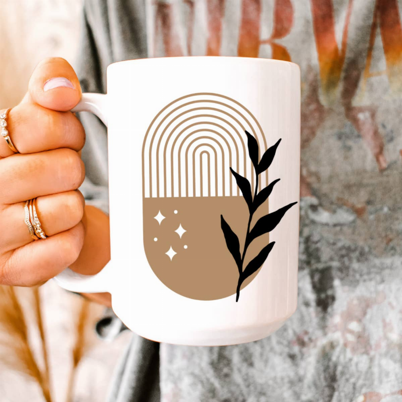White ceramic coffee mug with rainbow arch lines and black plant silhouette, C-shaped handle
