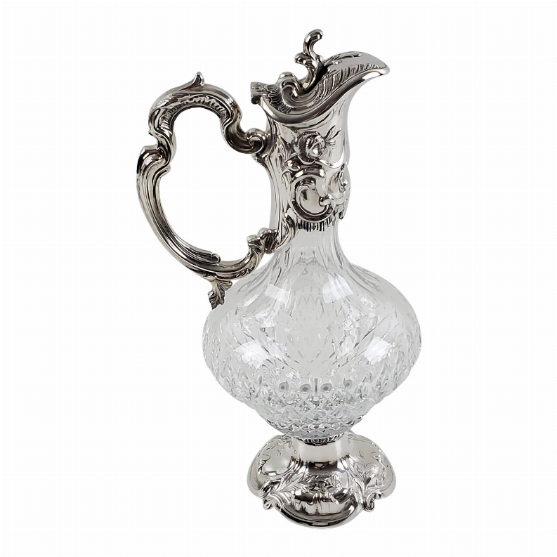 Ornate crystal claret jug with silver-plated handle and faceted French-cut body