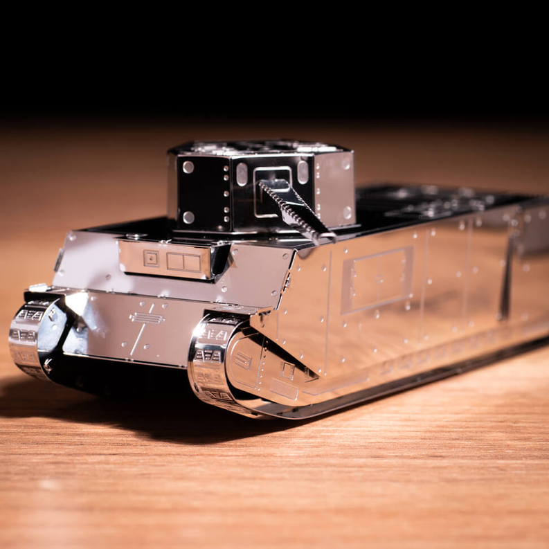 Gray metal tank model front view with raised gun and detailed turret hatches