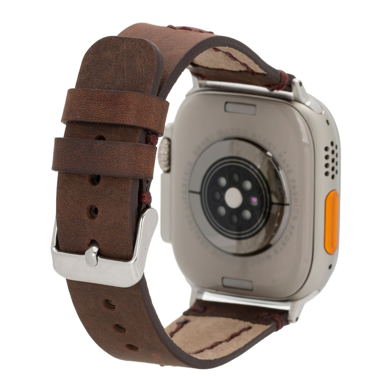 Dark brown leather Apple Watch band with perforations, silver case lugs, and stitching