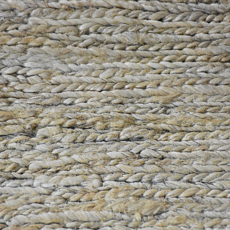Hand-woven jute rug close-up of braided fibers in beige, gray, and light green