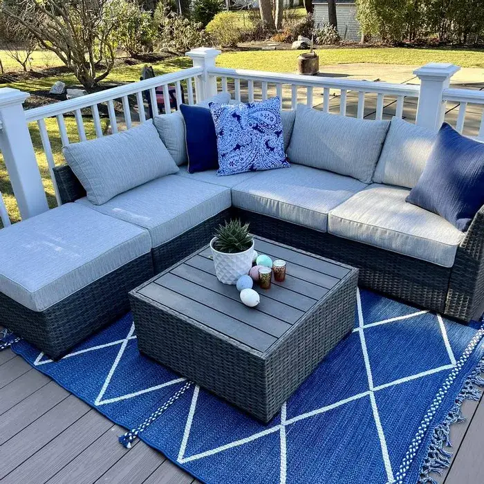 Indigo blue geometric patio area rug with white grid lines and tassel fringe corners