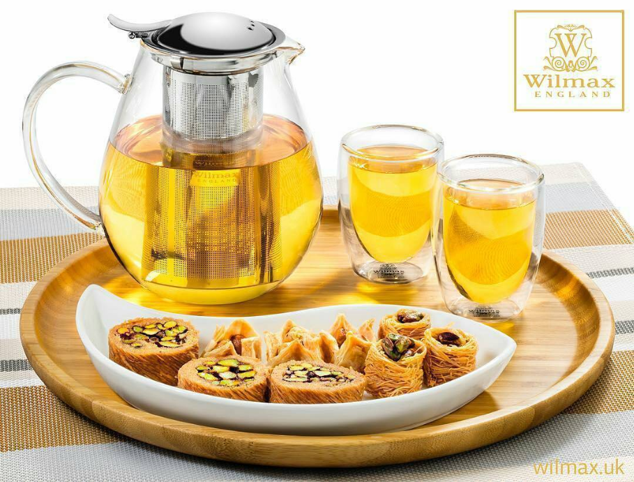 Round wooden serving tray featuring a teapot, three cups, and a food dish