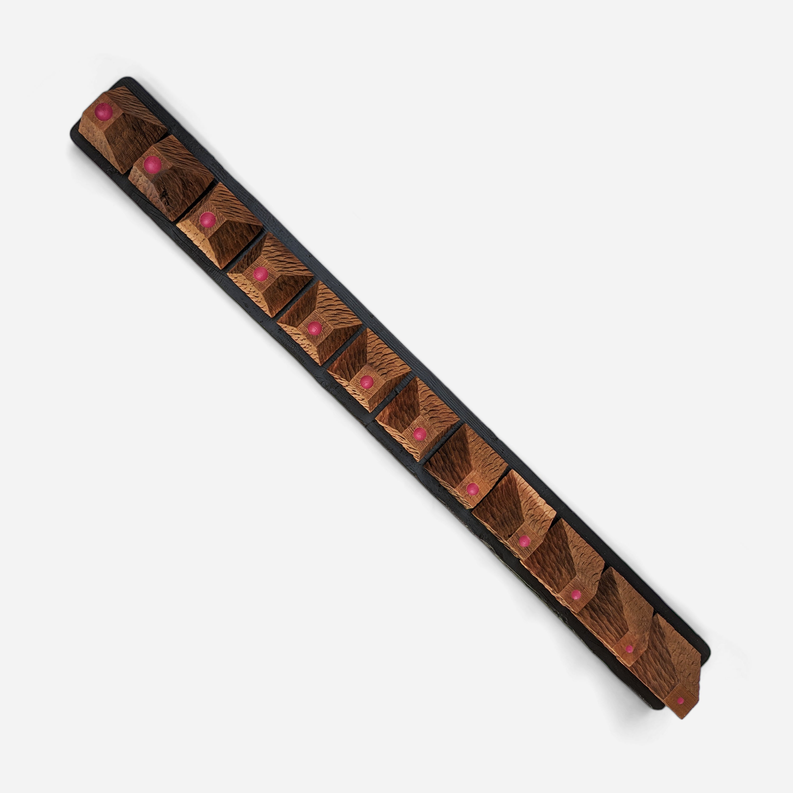 Wood wall art panel in diagonal view with patterned wood and purple dowel studs