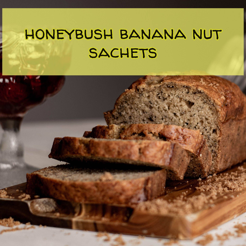 Honeybush banana nut tea sachets with banana-nut bread slices on a wooden board