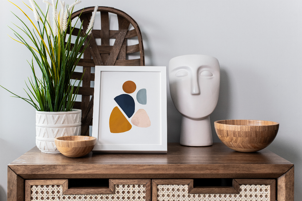 Square abstract framed art print with multicolor geometric shapes on shelf