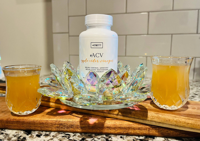 Apple cider vinegar supplement bottle with #ACV label and foil capsule packets on table