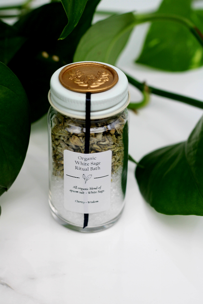 Organic bath salt jar with gold lid, clear glass, and a printed ingredient label.
