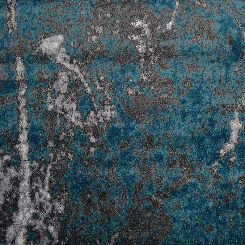 Abstract area rug pattern with mottled blue and gray blocks, distressed look.