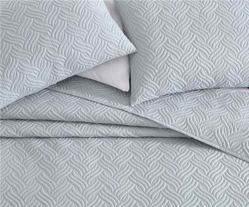 Gray quilted comforter with chevron stitch pattern