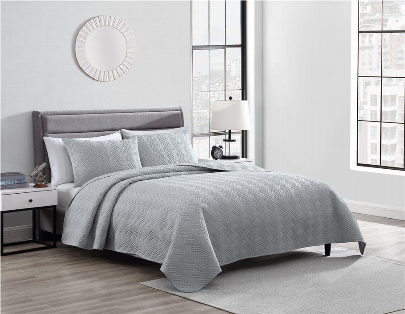 Gray queen duvet set with two matching shams on bed