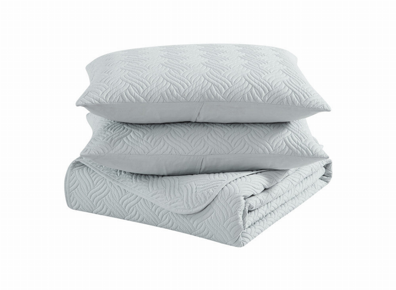 Gray folded duvet and pillows with textured chevron pattern