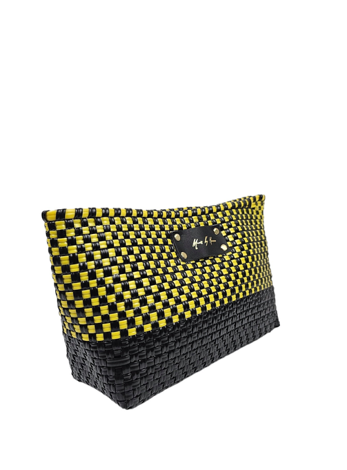 Woven clutch purse with yellow and black checker pattern and front metal logo tag