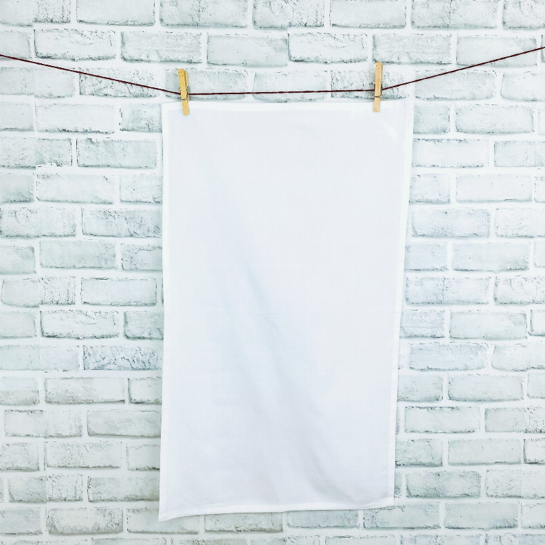 Bright white tea towel with loop, hanging on clothespins