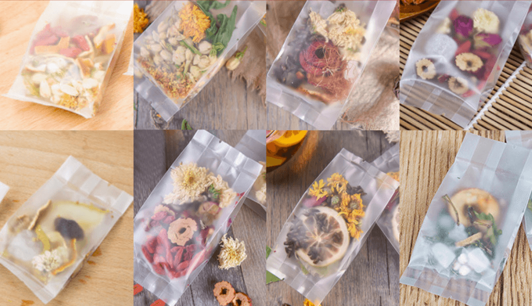 Loose tea blend packets with dried flowers and fruit pieces in clear pouches