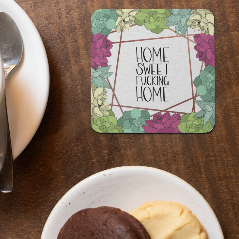 Rounded square coaster featuring “Home Sweet Fucking Home” text surrounded by colorful floral vines