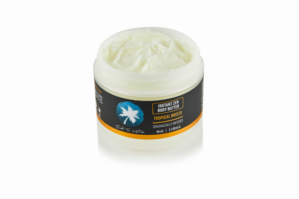 Instant body butter jar filled with pale yellow-green cream and orange-banded label