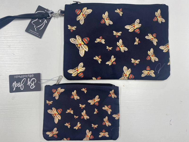Navy blue zipper accessory pouches with repeating bee pattern, two sizes shown.