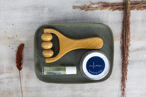 Soothing set with wooden scalp massager, balm jar, and oil bottle in tray