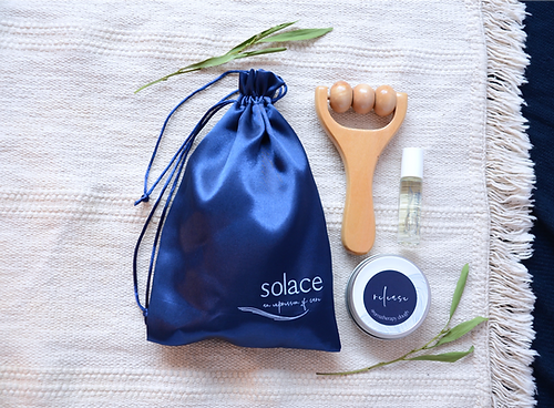 Soothing set with blue drawstring pouch, wooden scalp massager, balm jar, and oil bottle