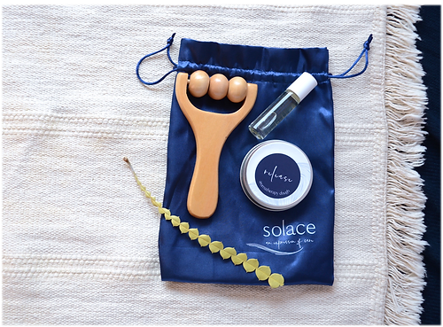 Soothing set pouch with wooden scalp massager, balm jar, and clear oil bottle