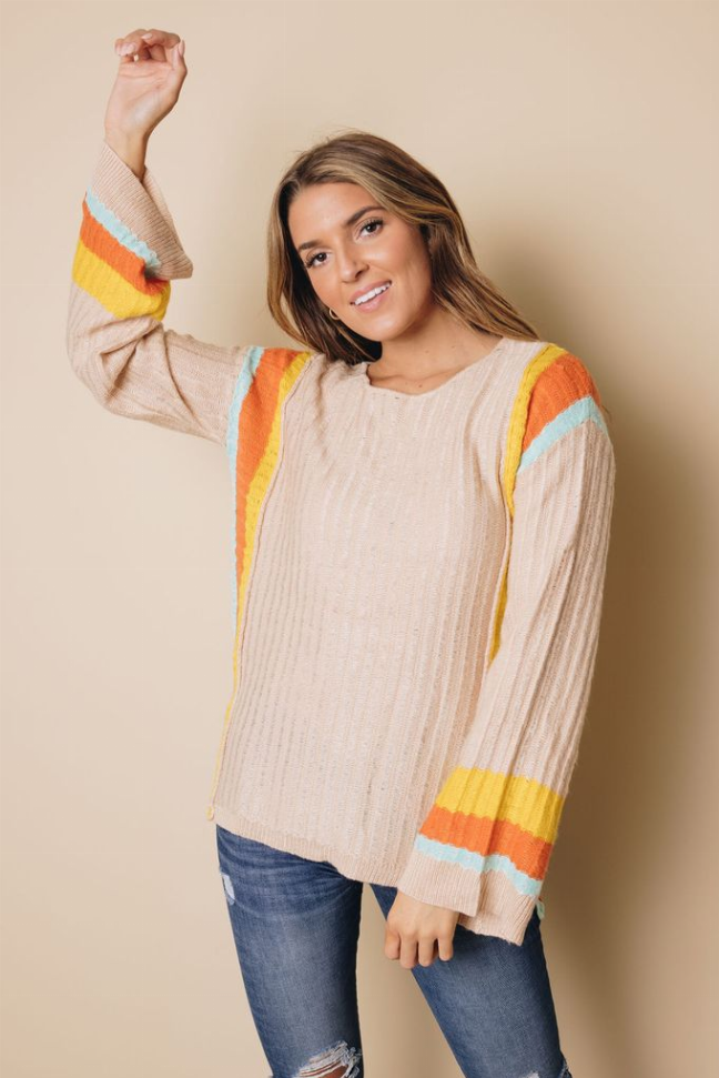 Cream knit sweater with rainbow striped long bell sleeves and ribbed cuffs, round neck