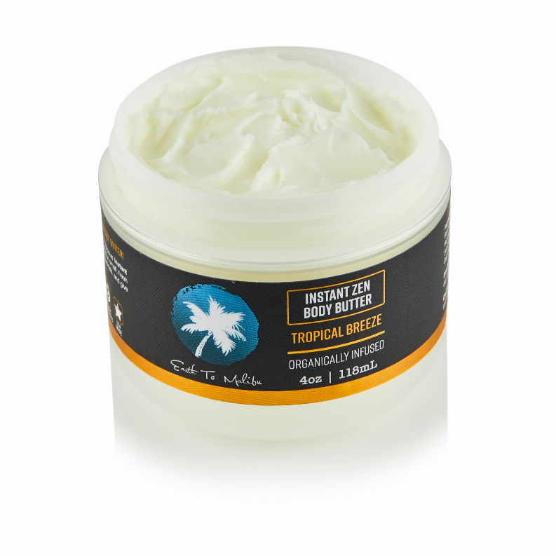 Body butter jar with white lid, Tropical Breeze label, pale yellow butter inside.