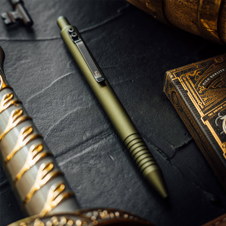 Olive green ballpoint pen close-up with ridged grip and black clip