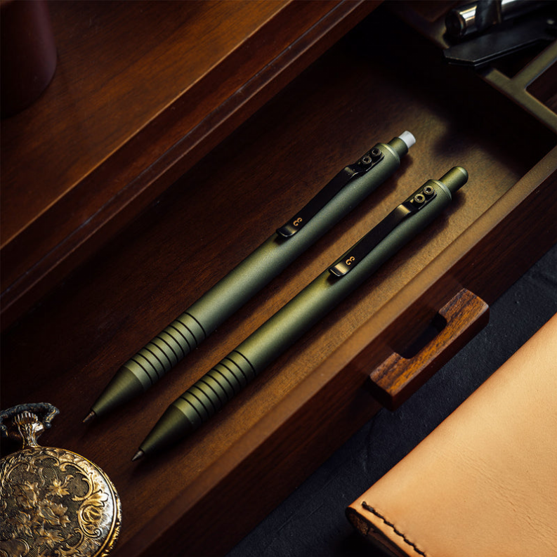 Olive green ballpoint pen with ridged grip and black clip, pair shown in open case