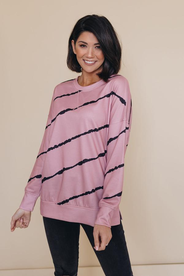 Dusty pink tie-dye striped pullover with dark diagonal stripes, crewneck, long sleeves