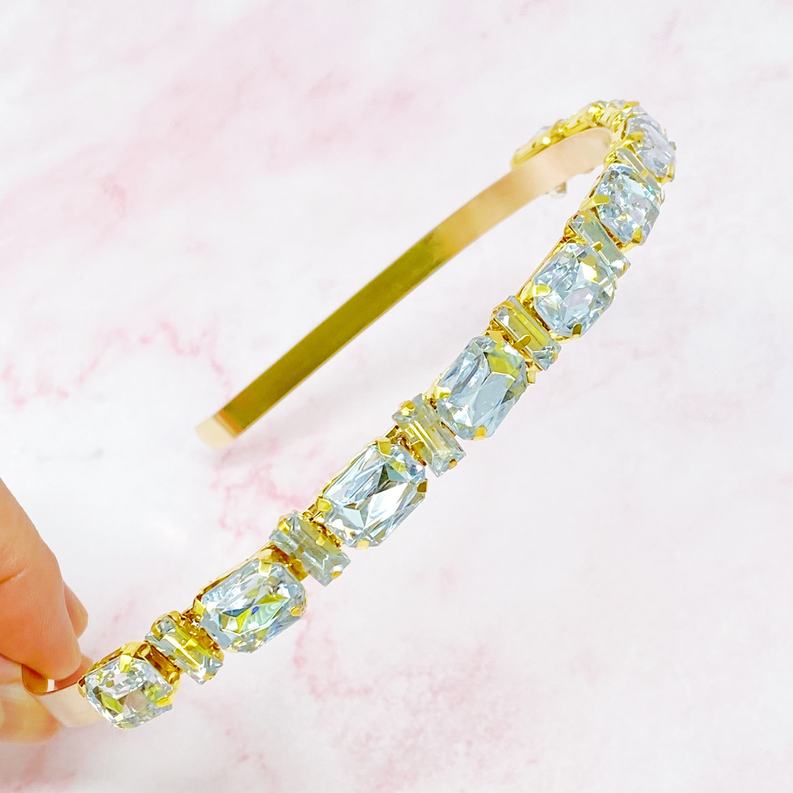 Clear rhinestone headband with gold-tone band and row of square-cut stones